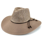 A woven straw wide-brim hat in a light tan color, featuring a dark brown band and drawstring closure on the side, set against a plain white background.