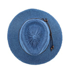 A blue woven straw sun hat with a circular brim, featuring a dark brown decorative cord with bead tassels on the side, shown from a top-down view on a white background.